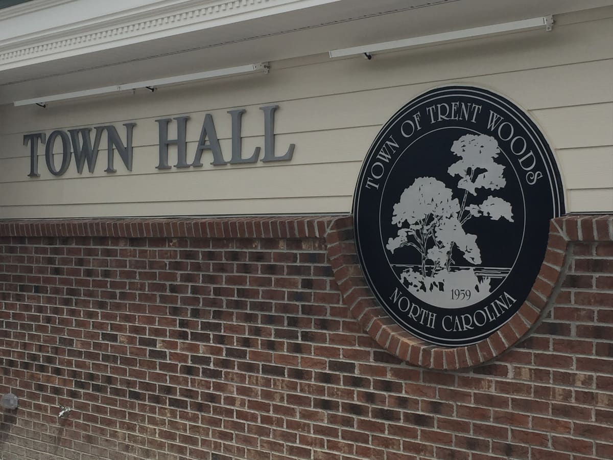 Dimensional TOWN HALL letters and the Town of Trent Woods seal on a brick municipal building